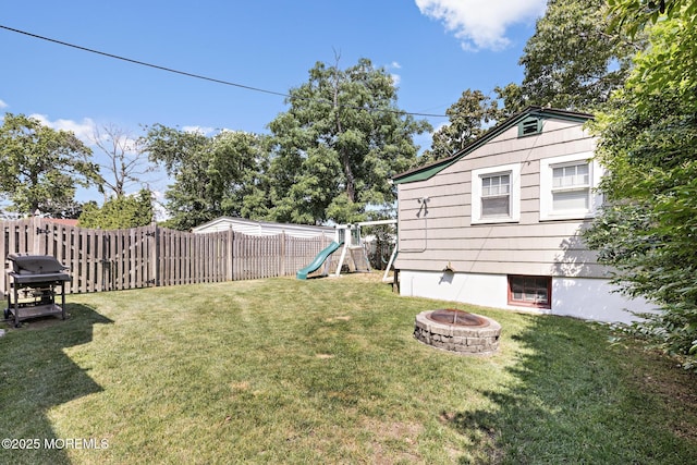 312 Lake Dr, Allenhurst, NJ 07711 - fenced backyard featuring a playground and an outdoor fire pit