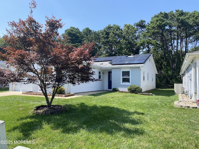 97 Yorkwood Dr, Brick, NJ 08723 - view of front facade with roof mounted solar panels, a front lawn, and brick siding