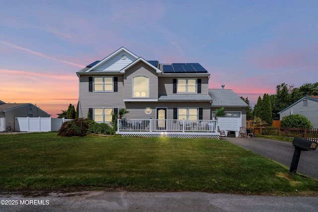 1020 Sarasota Dr, Forked River, NJ 08731 - traditional-style house with driveway, solar panels, an attached garage, and a porch