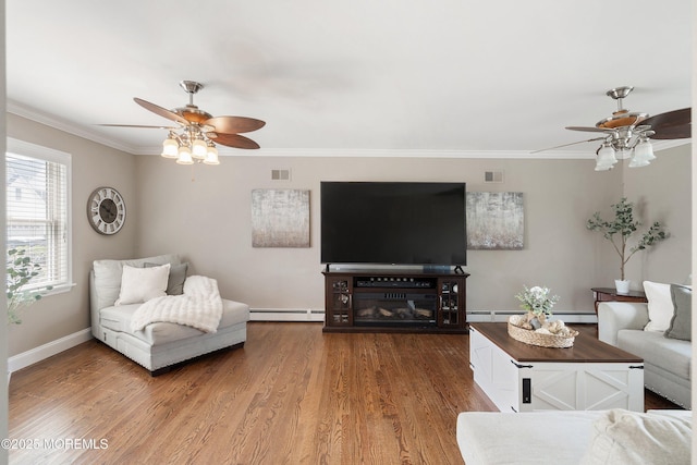 1020 Sarasota Dr, Forked River, NJ 08731 - living room with ceiling fan, a baseboard heating unit, ornamental molding, wood finished floors, and a baseboard radiator