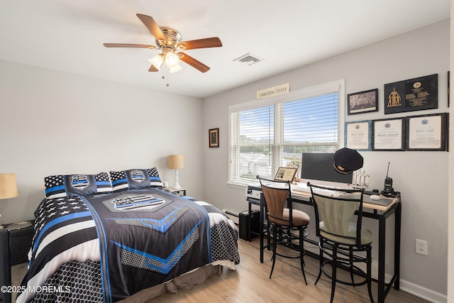 1020 Sarasota Dr, Forked River, NJ 08731 - bedroom featuring wood finished floors, ceiling fan, and baseboard heating