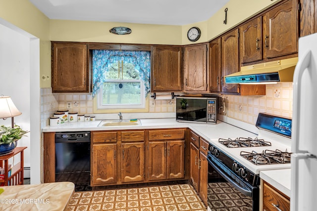 13 Millbrook Ct, Toms River, NJ 08757 - kitchen with black appliances, under cabinet range hood, light countertops, and backsplash