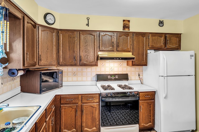 13 Millbrook Ct, Toms River, NJ 08757 - kitchen featuring white appliances, under cabinet range hood, tasteful backsplash, and light countertops