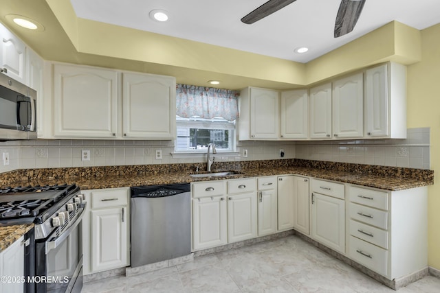64 Scarlet Dr, Parlin, NJ 08859 - kitchen with appliances with stainless steel finishes, dark stone countertops, white cabinets, backsplash, and ceiling fan