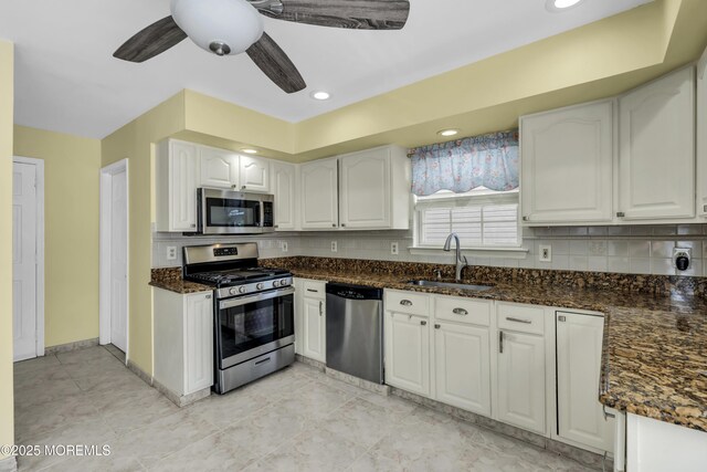 64 Scarlet Dr, Parlin, NJ 08859 - kitchen featuring appliances with stainless steel finishes, white cabinets, backsplash, ceiling fan, and dark stone counters