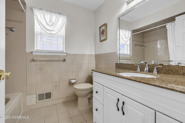 64 Scarlet Dr, Parlin, NJ 08859 - bathroom featuring tile patterned floors, vanity, tile walls, shower / bathtub combination with curtain, and a wainscoted wall