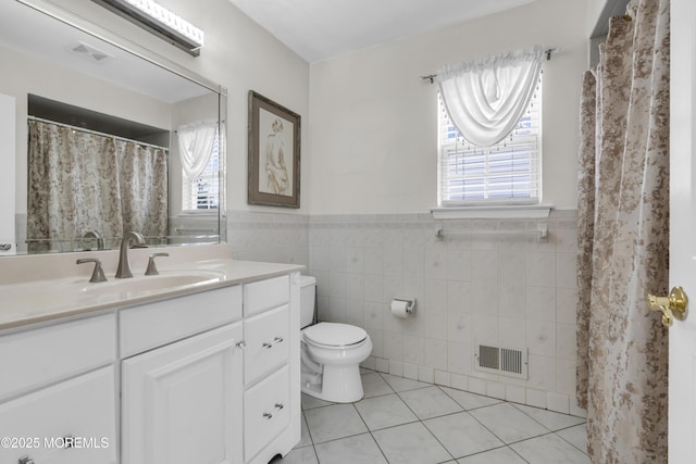 64 Scarlet Dr, Parlin, NJ 08859 - full bath with tile walls, tile patterned flooring, vanity, plenty of natural light, and wainscoting