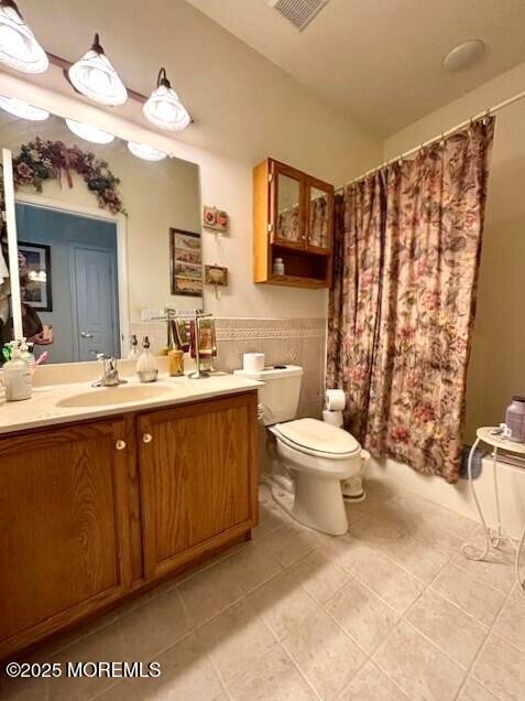 17 Marigold Ln, Little Egg Harbor, NJ 08087 - bathroom with vanity, tile patterned floors, curtained shower, and a wainscoted wall