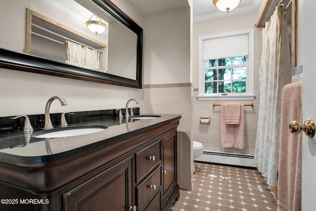 147 Montrose Rd, Colts Neck, NJ 07722 - full bath with a baseboard heating unit, tile walls, double vanity, crown molding, and wainscoting