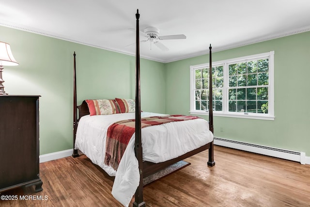 147 Montrose Rd, Colts Neck, NJ 07722 - bedroom featuring baseboard heating, wood finished floors, a ceiling fan, and ornamental molding