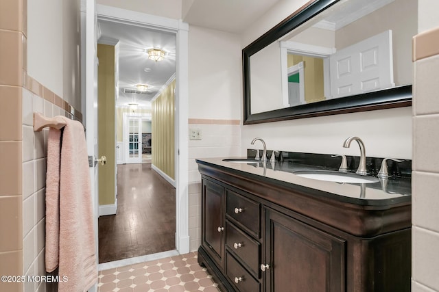 147 Montrose Rd, Colts Neck, NJ 07722 - bathroom featuring tile walls, double vanity, a wainscoted wall, and tile patterned flooring