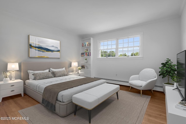 147 Montrose Rd, Colts Neck, NJ 07722 - bedroom featuring a baseboard heating unit, crown molding, and light wood finished floors