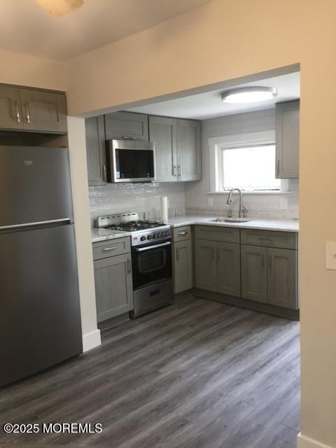 240 Beachwood Blvd, Beachwood, NJ 08722 - kitchen featuring stainless steel appliances, tasteful backsplash, light countertops, and dark wood-style flooring