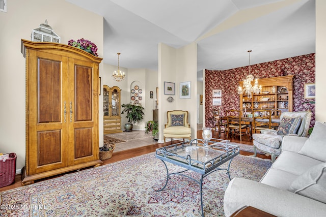 43 Bradley Beach Way, Waretown, NJ 08758 - living room featuring a chandelier, wood finished floors, wallpapered walls, and lofted ceiling