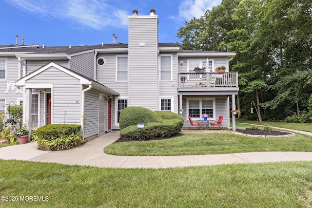 363 Yorkshire Pl, Morganville, NJ 07751 - view of front of property with a chimney, a front lawn, a balcony, and a patio