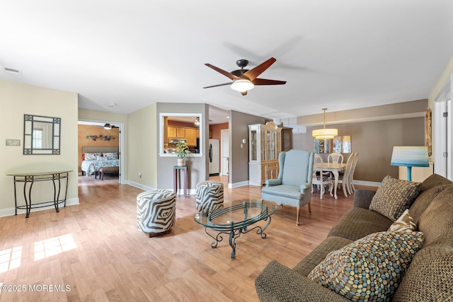 363 Yorkshire Pl, Morganville, NJ 07751 - living room featuring a ceiling fan and light wood-style floors