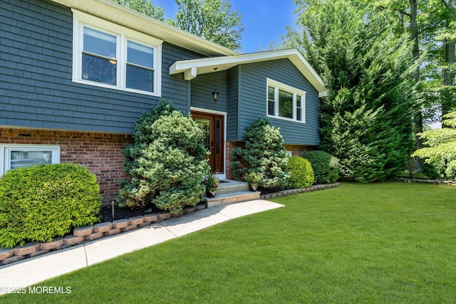 1617 Doris St, Wall, NJ 07719 - view of front facade with brick siding and a front yard
