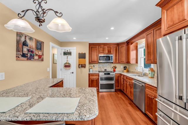 1617 Doris St, Wall, NJ 07719 - kitchen featuring stainless steel appliances, light wood-style floors, brown cabinets, and recessed lighting