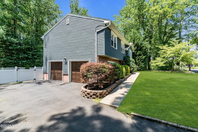 1617 Doris St, Wall, NJ 07719 - view of home's exterior with an attached garage, driveway, and brick siding