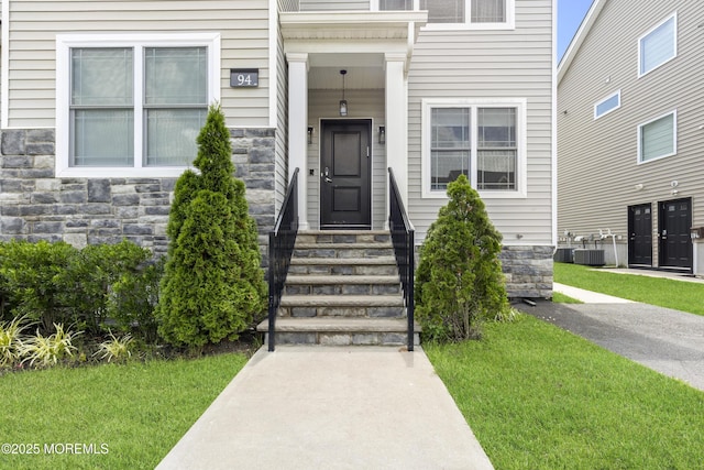 94 Bradhurst Ave, Lakewood, NJ 08701 - entrance to property with stone siding and a lawn
