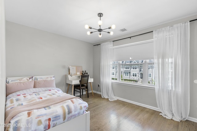 94 Bradhurst Ave, Lakewood, NJ 08701 - bedroom with a chandelier and wood finished floors