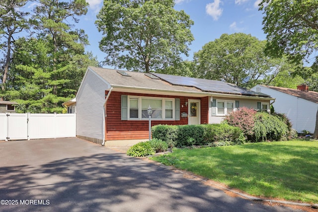 8 N Cherokee Ln, Brick, NJ 08724 - view of front of home with roof mounted solar panels, a gate, and asphalt driveway