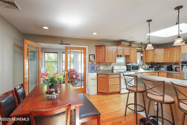 8 N Cherokee Ln, Brick, NJ 08724 - kitchen with appliances with stainless steel finishes, backsplash, light wood finished floors, pendant lighting, and recessed lighting