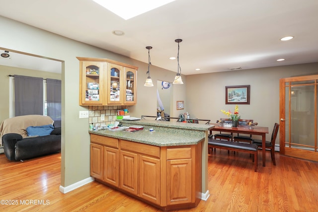8 N Cherokee Ln, Brick, NJ 08724 - kitchen with a peninsula, light wood-style flooring, hanging light fixtures, glass insert cabinets, and recessed lighting