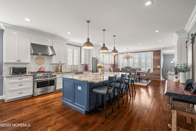 114 3rd Ave, Bradley Beach, NJ 07720 - kitchen featuring stainless steel appliances, exhaust hood, white cabinetry, crown molding, and decorative backsplash
