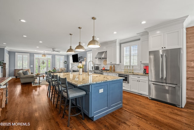 114 3rd Ave, Bradley Beach, NJ 07720 - kitchen with freestanding refrigerator, crown molding, white cabinets, wall chimney range hood, and recessed lighting