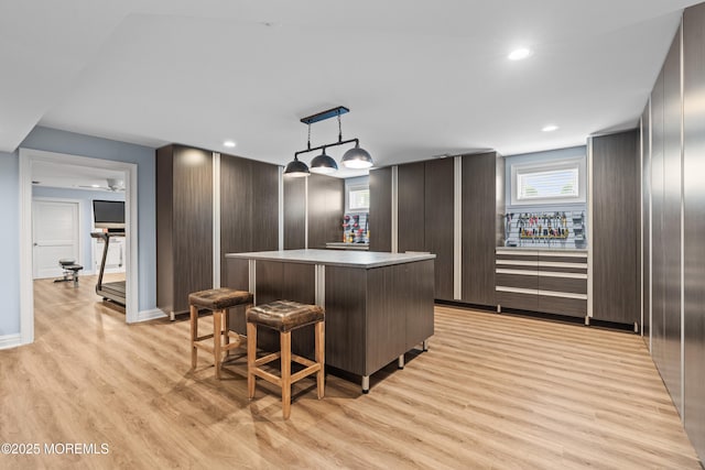 114 3rd Ave, Bradley Beach, NJ 07720 - kitchen featuring light wood-type flooring, a center island, modern cabinets, a breakfast bar area, and pendant lighting