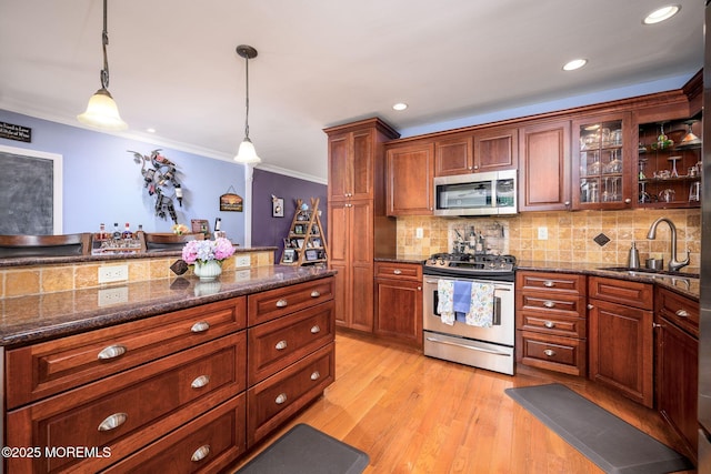 2 Darien Cir, Howell, NJ 07731 - kitchen featuring appliances with stainless steel finishes, pendant lighting, ornamental molding, backsplash, and glass insert cabinets