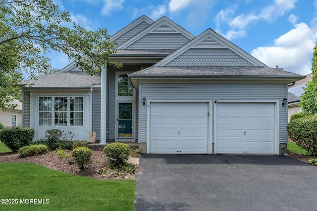 12 Drayton Rd, Manchester, NJ 08759 - view of front of house with driveway, an attached garage, and a shingled roof