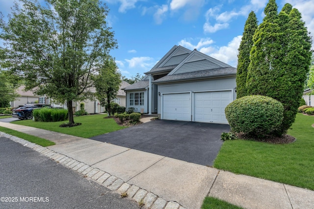 12 Drayton Rd, Manchester, NJ 08759 - view of front of home with asphalt driveway, an attached garage, a front yard, and roof with shingles
