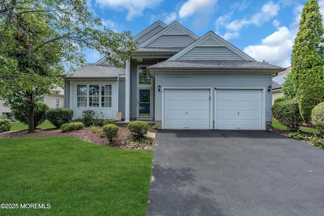 12 Drayton Rd, Manchester, NJ 08759 - view of front of home with an attached garage, asphalt driveway, a front yard, and a shingled roof