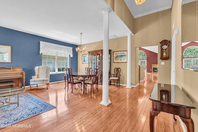 12 Drayton Rd, Manchester, NJ 08759 - dining room featuring decorative columns, light wood-type flooring, a chandelier, and crown molding