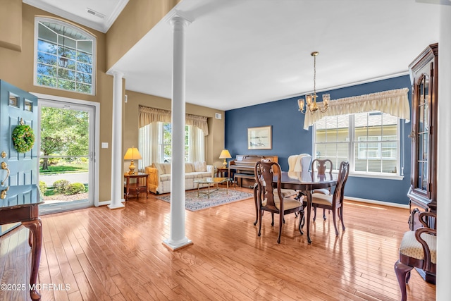 12 Drayton Rd, Manchester, NJ 08759 - dining room with ornate columns, ornamental molding, light wood-type flooring, and a chandelier