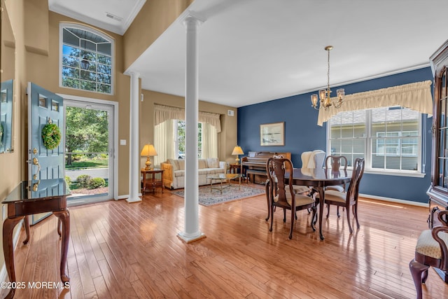 12 Drayton Rd, Manchester, NJ 08759 - dining space featuring decorative columns, wood-type flooring, ornamental molding, and a chandelier