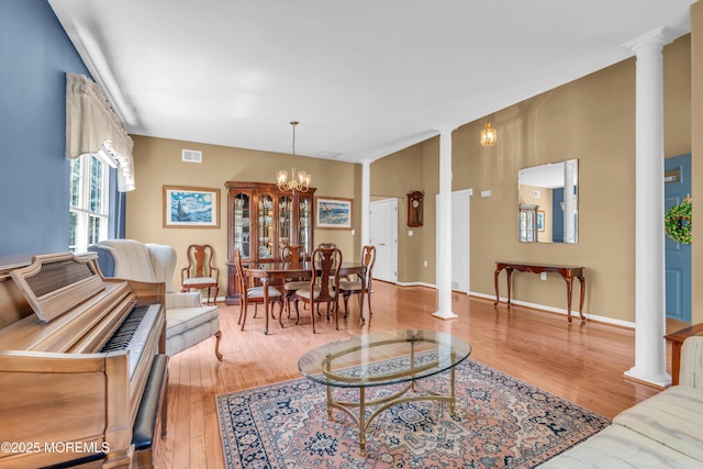 12 Drayton Rd, Manchester, NJ 08759 - living room featuring decorative columns, wood finished floors, and a chandelier