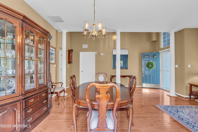 12 Drayton Rd, Manchester, NJ 08759 - dining area featuring decorative columns, light wood-type flooring, and a chandelier