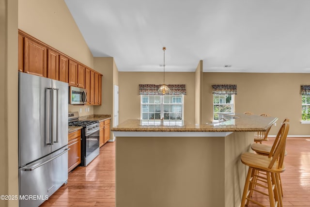 12 Drayton Rd, Manchester, NJ 08759 - kitchen with appliances with stainless steel finishes, light wood-style flooring, healthy amount of natural light, and brown cabinets