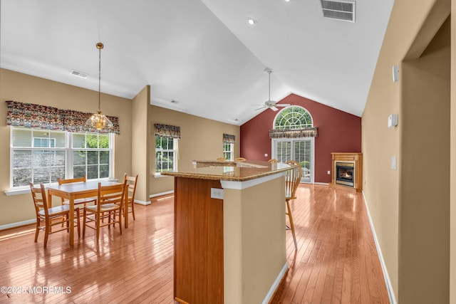 12 Drayton Rd, Manchester, NJ 08759 - kitchen featuring light wood finished floors, lofted ceiling, open floor plan, pendant lighting, and a lit fireplace
