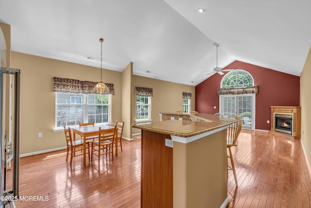12 Drayton Rd, Manchester, NJ 08759 - kitchen featuring a glass covered fireplace, a ceiling fan, light wood-style floors, vaulted ceiling, and open floor plan
