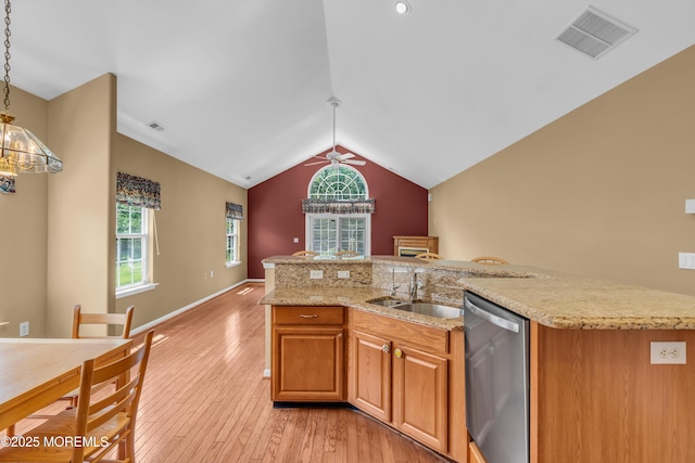 12 Drayton Rd, Manchester, NJ 08759 - kitchen with stainless steel dishwasher, lofted ceiling, light wood-type flooring, hanging light fixtures, and light stone counters