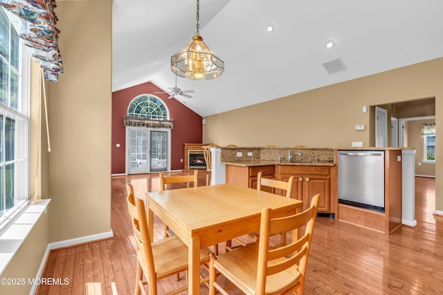 12 Drayton Rd, Manchester, NJ 08759 - dining room featuring ceiling fan, lofted ceiling, light wood finished floors, a lit fireplace, and plenty of natural light
