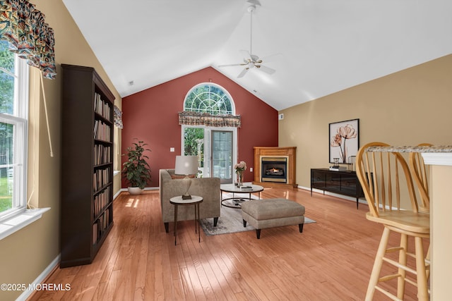 12 Drayton Rd, Manchester, NJ 08759 - living area featuring ceiling fan, light wood finished floors, a warm lit fireplace, and high vaulted ceiling