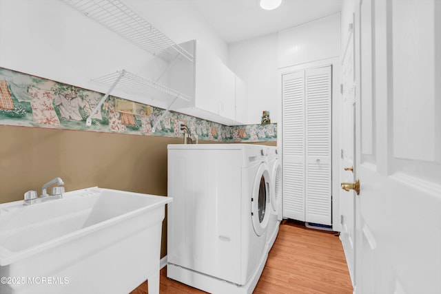 12 Drayton Rd, Manchester, NJ 08759 - washroom with washer and clothes dryer, cabinet space, and light wood-style flooring