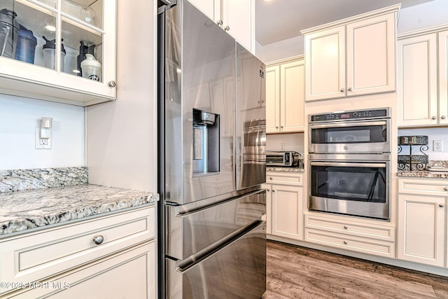 14 Festival Ct, Howell, NJ 07731 - kitchen with stainless steel appliances, cream cabinetry, wood finished floors, and light stone counters