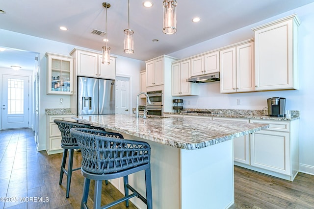 14 Festival Ct, Howell, NJ 07731 - kitchen with stainless steel appliances, under cabinet range hood, a breakfast bar, wood finished floors, and recessed lighting