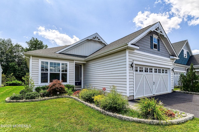 14 Festival Ct, Howell, NJ 07731 - view of front facade with a front lawn, driveway, and a shingled roof